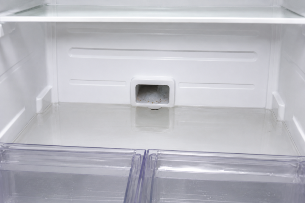 Samsung refrigerator clogged defrost drain causing water accumulation inside the refrigerator